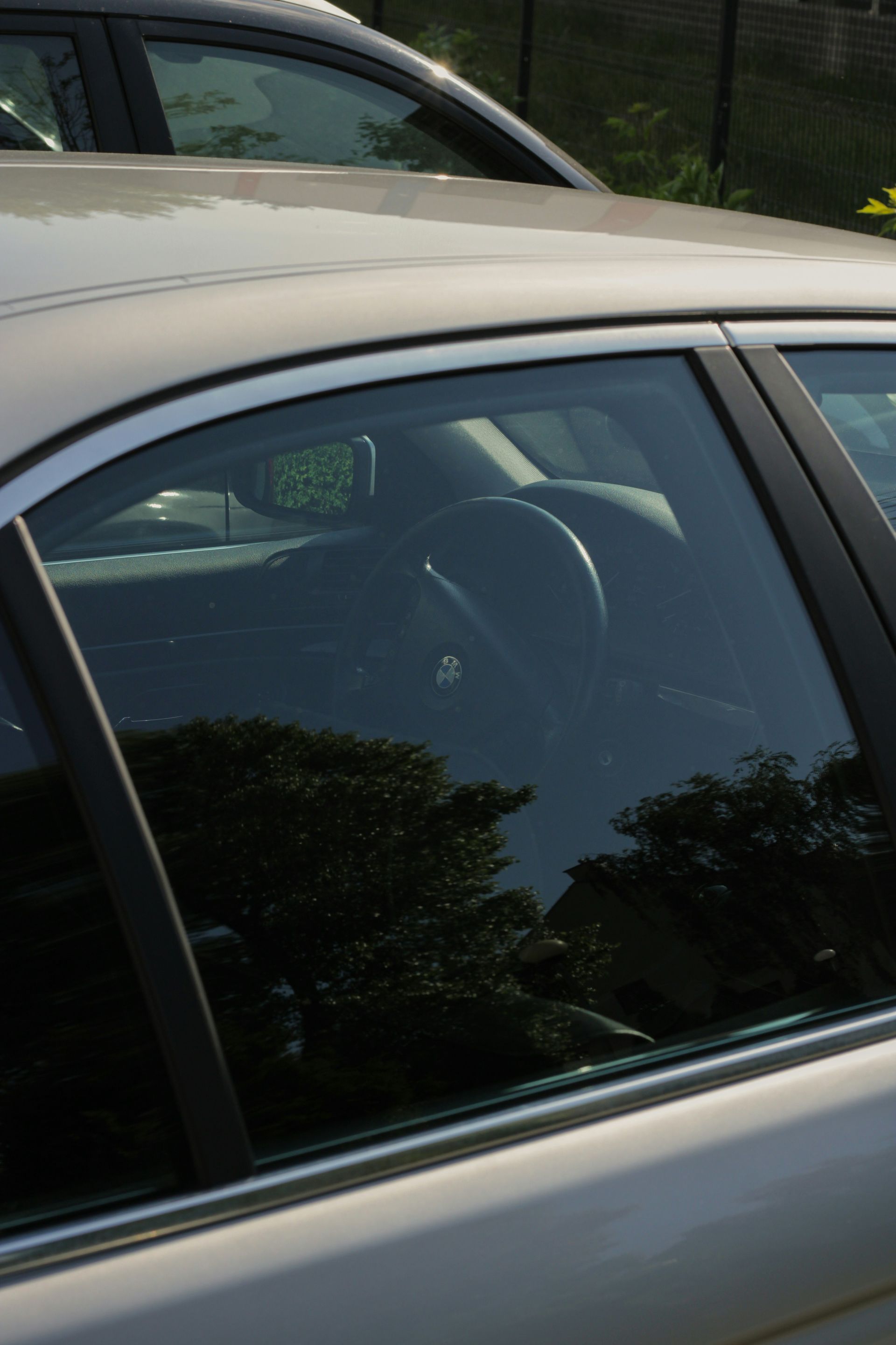 a white car parked in a parking lot next to another car
